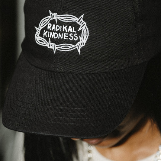 Vegan black cap 'Radikal kindness' portrait front